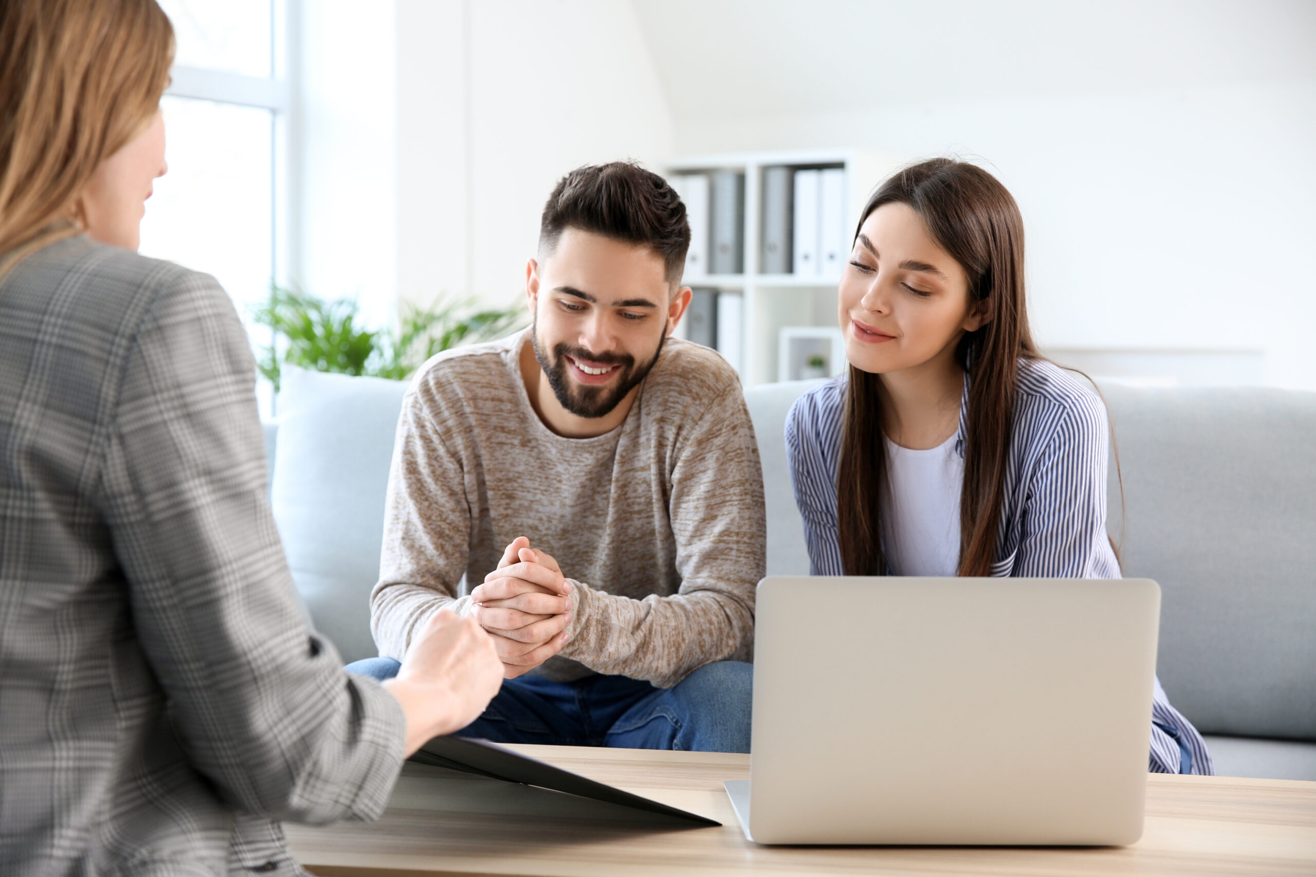 Young couple in office of real estate agent