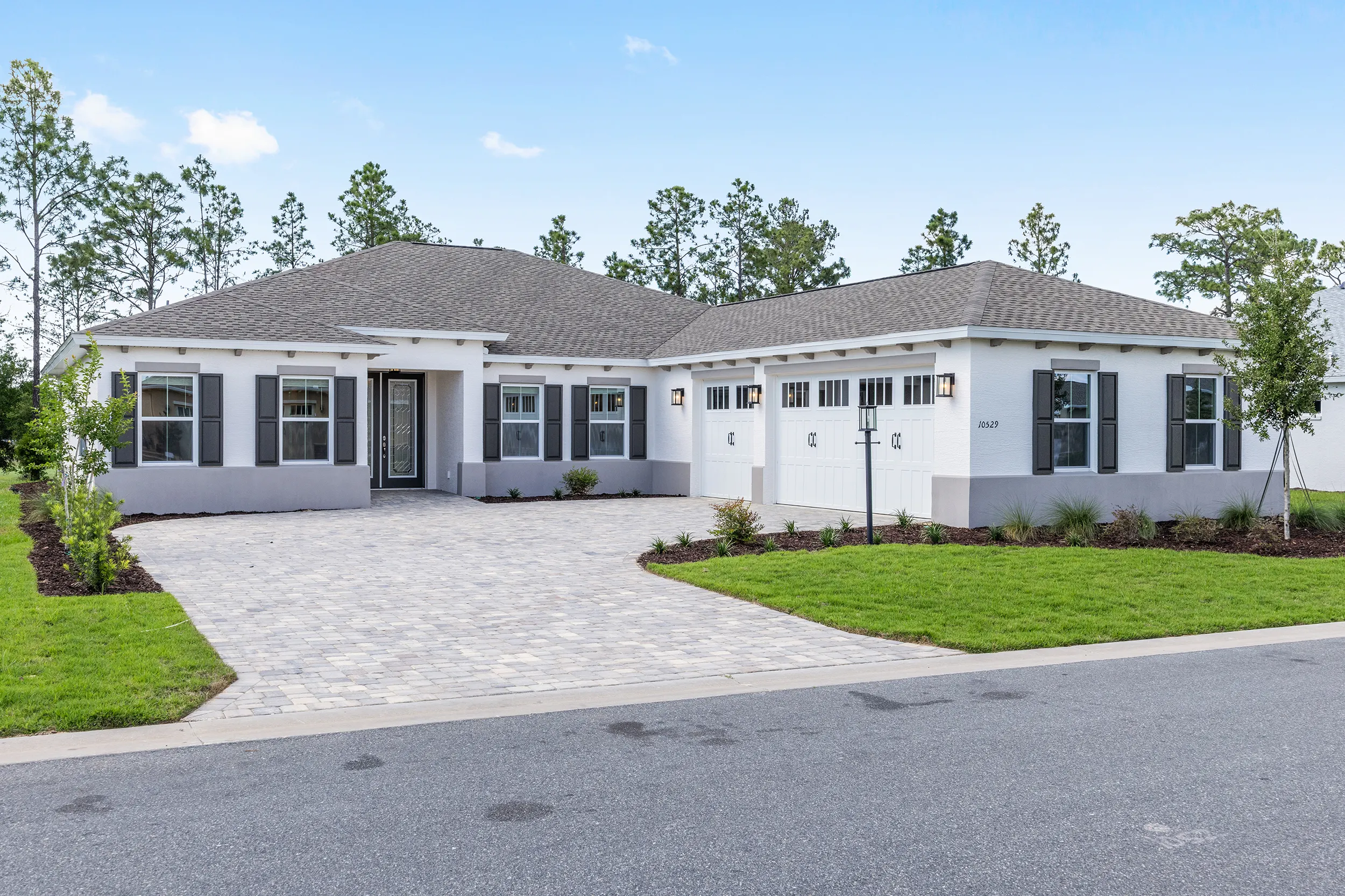MIR_10529-SW-96th-Lane-Road-Ocala-Lot11-Front -exterior Northampton model - modern residence with lots of light and plenty of garage space in Longleaf Ridge Community in Ocala Florida
