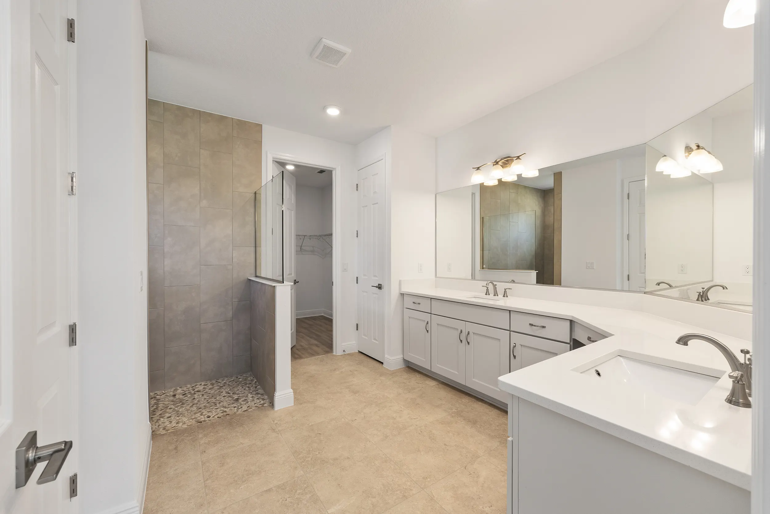 MIR_10529-SW-96th-Lane-Road-Ocala-Lot11-master-bath Northampton model - modern primary bathroom with large shower, his and her sinks, and walk in closet in Longleaf Ridge Community in Ocala Florida
